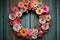 whimsical paper flower wreath on a rustic wooden door