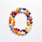 Whimsical Pill Art: The Letter O Crafted With Colorful Pills