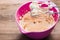 Whipped butter, bowl with butter and whisk for beating on a wooden table, mixer