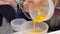 Whipped egg yolks with sugar in a glass bowl. Beaten egg yolks in a bowl with whisk. Beaten egg yolk