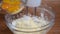 Whipping cream with electric mixer. Add yolk while mixing cream in glass bowl. Home bakery.
