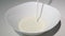 Whipping cream is poured into a bowl