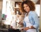 Whipping up something delicious just for you. Portrait of a happy young woman preparing a meal on the stove at home.