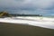 Whirinaki beach near Napier. Dark volcanic stones on beach, Hawke`s Bay, Napier