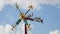 A whirligig spins in the daylight.