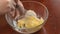Whisk the eggs with sugar close-up. Woman hands mixes eggs with sugar to cook cooking. Whisking food ingredients in a
