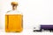 Whiskey bottle and a toy truck speeding towards the bottle, professional driving and alcohol, white background