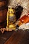 Whiskey bottles.kerosene lantern style oil lamps, wooden barrel. Still life. Copy space.