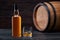 Whiskey glass and bottle on the old wooden table