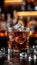 Whiskey glass with ice cubes on dark atmospheric background, ideal for text placement