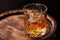 Whiskey glass with ice on a rustic barrel, a classic sip