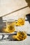 Whiskey in glasses on table in bright sunlight, yellow drink