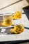 Whiskey in glasses on table in bright sunlight, yellow drink