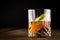Whiskey with Slices of Green Apple on Wooden Table and black background.