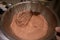 Whisking in a bowl of cocoa powder mix.