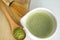 Whisking green Japanese Matcha powder in chawan with chasen