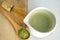 Whisking green Japanese Matcha powder in chawan with chasen