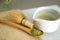 Whisking green Japanese Matcha powder in chawan with chasen