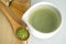 Whisking green Japanese Matcha powder in chawan with chasen