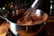 whisking hot chocolate mixture in a saucepan