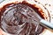 Whisking melted chocolate sauce in bowl up-close