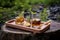 whisky-infused cocktails on wooden tray outdoors