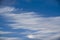 Whispy white clouds in the ocean blue sky