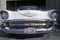 A white 1957 Chevrolet convertible with a Washington license plate reading 57 CHV
