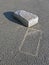 White abandoned brick with silhouette on asphalt,