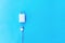 White Ñable phone chargers on blue background. Top view. Objects on a simple background