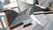 White abstract polygonal broken shapes fluctuate seamless loop. 3D animation.