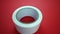 White adhesive tape roll turns and falls on red background