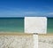 White advice panel on a beach with ocean on the background. for graphical concept