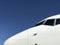 White Aeroplane Nose against clear Blue Sky 3