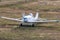 White aircraft for spraying agricultural fields at the airfield with a running engine