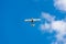 White airplane and blue sky. Small passenger plane flying in the blue sky. Light-engine aircraft and blue sky.Airplane in the sky