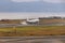 A white airplane landing touch down at Osaka airport, Japan