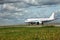 White airplane moves along Runway