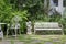 White alloy bench in outdoor garden