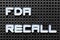 White alphabet with word fda recall on black pegboard background