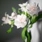 White alstroemeria flowers with green leaves on gray background with sun light and shadow close up