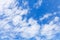 White altocumulus clouds layer in blue sky at daytime, natural background