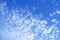 White Altocumulus Clouds Scattered on Vibrant Blue Sky