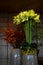 White amaryllis, bunch of creme-white amaryllis and bunch of red berries and grass in vases