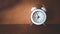 White analog clock on dark brown wood background, time passing concept , deadline , reminder, schedule and planning