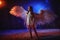 White angel on a dark background with colored lighting. The concept of war between good and evil. Girl with angel wings during a