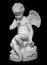 White angel figurine isolated on black background. Cupid sculpture. Stone statue of young cherub