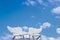 White angel wings on bright blue sky clouds vast space background