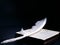 White angelic feather rests on the Bible holy book