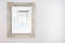 White antique vintage mirror wooden frame on white wall